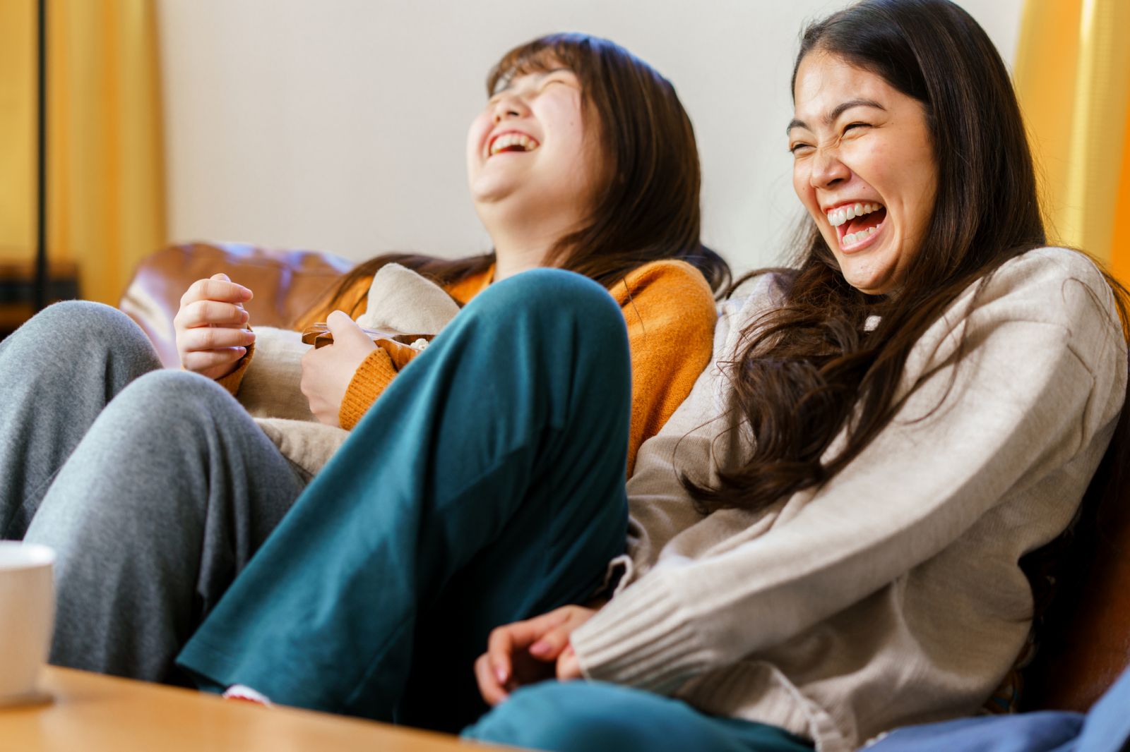 friends laughing watching tv student apartments near georgia tech​